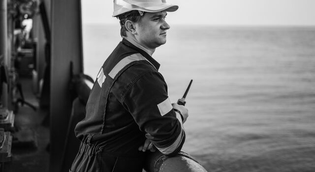 SINGLE-IMAGE_male-engineer-on-deck-holding-walkie-talkie_jul24