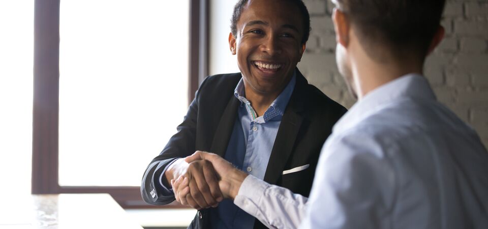 COLOUR-IMAGE_men-shaking-hands-smiling-zoomed_feb26